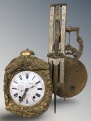 A continental gilt metal wall clock with enameled dial, length 85 cm.