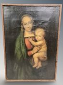 An antiquarian oleograph depicting the Madonna and child, in oak frame, 45 cm x 33 cm.