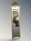A reproduction rectangular gilt framed mirror with crest above,