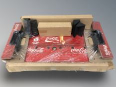 A Coca Cola display stand in packaging