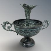 A patinated metal twin handled bowl, height 14 cm, and a similar candlestick.