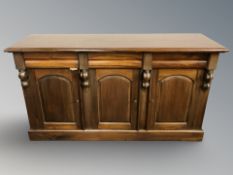 A Victorian style stained hardwood sideboard, fitted cupboards and drawers,