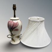 A Moorcroft Magnolia table lamp with shade, height up to fitting 38 cm.