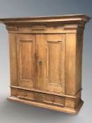 A large continental panelled oak cabinet on turned bulbous feet,