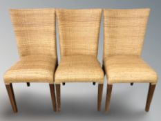 A set of six woven wicker dining chairs