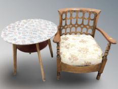 A melamine circular occasional table and a floral upholstered armchair.