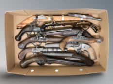 A group of ornamental flintlock pistols.