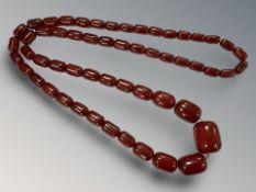 A graduated cherry amber necklace, with fifty five lozenge shaped beads, gross weight 90g.