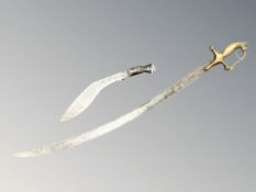 An Indian talwar with brass lion's head pommel, length 90 cm, together with a kukri.
