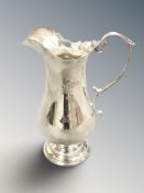 An Edwardian silver cream jug, London 1905, height 13cm.