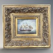A gilt framed picture depicting a four masted military vessel at sea, 19 cm x 24 cm.