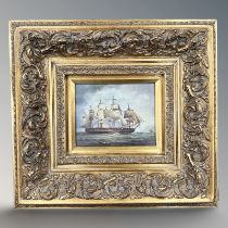 A gilt framed picture depicting a four masted military vessel at sea, 19 cm x 24 cm.