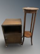 An Edwardian inlaid mahogany two tier plant stand and an Art Deco oak bedside cabinet.