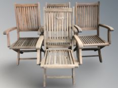 A set of four teak folding garden armchairs.