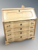 A Danish blonde oak serpentine front bureau, 97 cm x 47 cm x 101 cm.