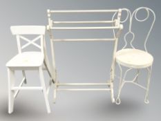 A modern painted towel rail and two chairs.