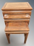 A Chinese hardwood nest of three tables,