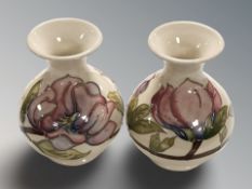 A pair of Moorcroft Magnolia bulbous vases, height 13 cm.