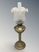 A brass oil lamp with etched frosted glass shade, height 67 cm.