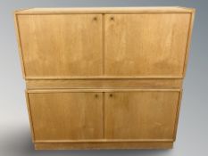 A pair of Danish oak veneer and MDF double door cabinets,