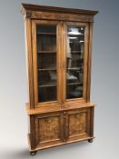 An early 20th century continental burr walnut double door bookcase, 109 cm W x 44 cm D x 210 cm H.