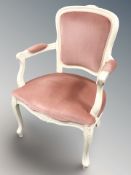 A continental painted armchair in pink draylon fabric.
