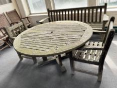 A weathered teak garden circular table, diameter 150 cm, and a pair of armchairs.