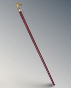 A walking stick with brass duck's head pommel, length 93 cm.