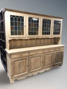 A Danish blonde oak stained and leaded glass dresser, 203 cm x 45 cm x 179 cm.