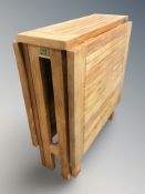 A teak drop leaf gate leg patio table, 130 cm L x 65 cm W x 73 cm H.