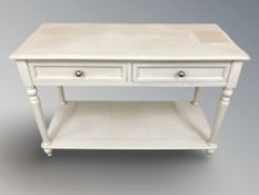 A painted two drawer side table, 121 cm W x 51 cm D x 79 cm H.