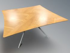 A Scandinavian laminated beech coffee table on metal support, width 100 cm.