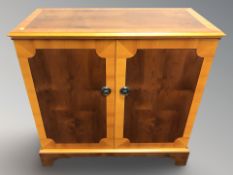 A reproduction yew wood entertainment cabinet, width 82 cm.