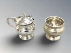 Two silver Lindisfarne pattern salts, one with hinged lid and blue glass liner, height 7.5 cm.