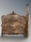 A French carved walnut and rosewood 4' bed frame