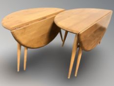 Two Ercol elm and beech drop leaf circular coffee tables, each 60 cm diameter.