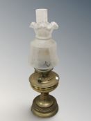 A brass oil lamp with etched frosted glass shade, height 63 cm.