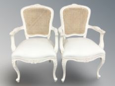 A pair of French style painted and cane backed salon armchairs,