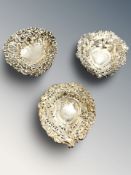 Three pierced silver heart shaped dishes, largest 9 cm long.