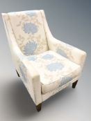A contemporary floral upholstered armchair,