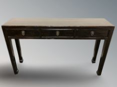 A Chinese lacquered pine three drawer side table,