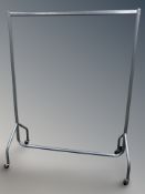 A metal clothes rail on castors,