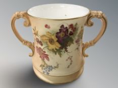 A Royal Worcester blush ivory twin handled cup, height 15.5 cm.