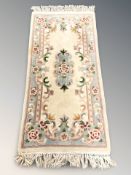 A Chinese rug, 170 cm x 76 cm.