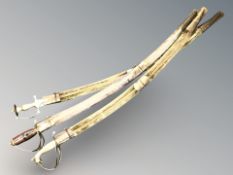 Three Indian swords with brass hilts.