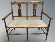 An Arts and Crafts style beech hall seat, width 110 cm.