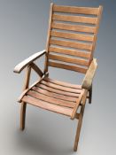 A folding teak garden armchair.
