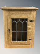 A Danish blond oak and leaded glass wall cabinet,