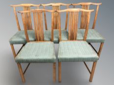 A set of five Danish teak dining chairs.
