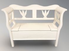 A painted storage settle, width 123 cm.